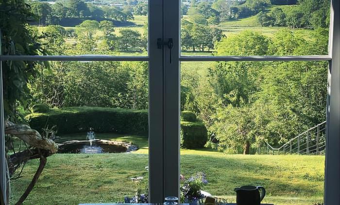 Guests take breakfast in the Dining Room with spectacular views over the Glaslyn Estuary to the sea and Rhinog mountains beyond.
